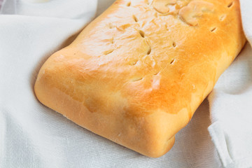 Yummy freshly baked pie is laid out on a white linen dish towel. Сlose-up shot.