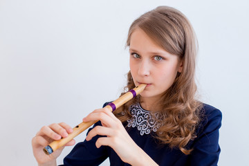 Girl playing on a flute © Nichizhenova Elena