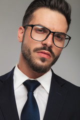 portrait of arrogant sexy businessman wearing eyeglasses
