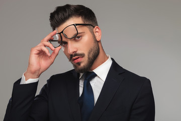 portrait of sensual businessman taking eyeglasses off