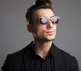 portrait of handsome fashion man with sunglasses looking to side