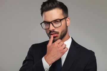 sexy businessman flirting with thumb on lips