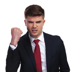 portrait of angry businessman shaking his fist in the air