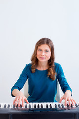Woman playing synthesizer