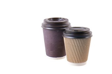 A pair of brown carton double walled paper cups, take out, coffee to go. Two colorful eco-friendly heat resistant cardboard mugs for hot beverages w/ cap, isolated, background, close up, copy space.