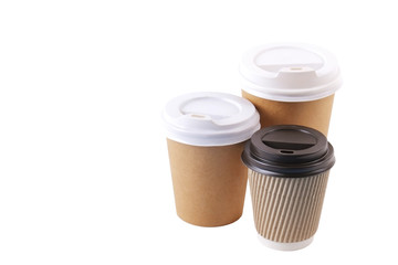 Three brown carton double walled paper cups, different sizes, take out, coffee to go. Colorful eco-friendly cardboard mugs for hot beverages w/ cap, isolated on white, background, close up, copy space