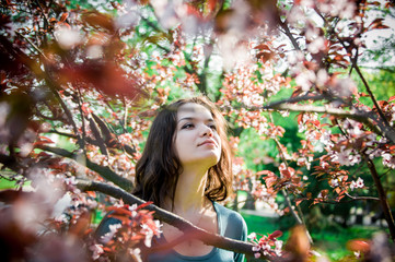 The beautiful young woman in a spring garden