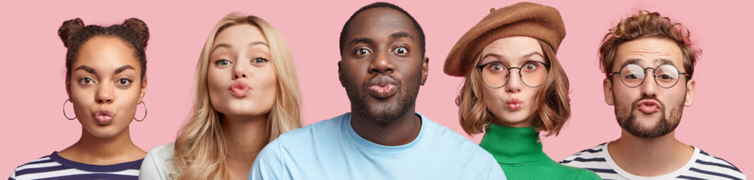 Portrait of two men and three women of different nationalities, keep lips rounded, make grimace at camera, isolated over pink studio background. People, diversity and facial expressions concept