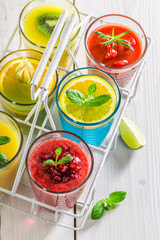 Tasty smoothie with fresh fruits in white basket