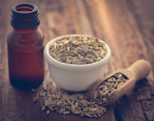 Fennel seeds with essential oil in a bottle