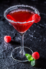 Red Margarita with raspberries and mint on black rock
