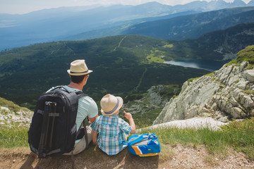 Fototapeta premium Father and son traveling in Rila mountains Bulgaria