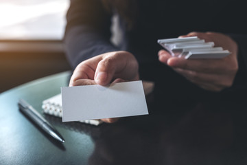 Businesswoman giving and showing an empty business card