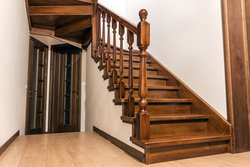 Modern brown oak wooden stairs  and doors in new renovated house interior