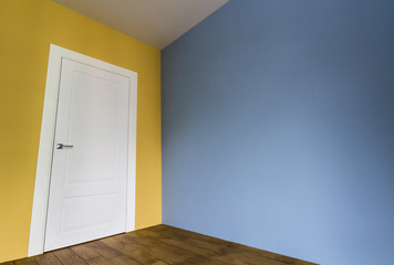 Fresh painted room interior with white door and wooden parquet floor after renovation