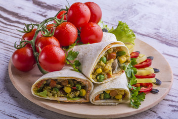 Tortilla, sauce, salad and tomato. Delicious and healthy meal. Mexican specialty. Mexican very popular specialty.