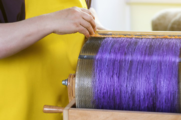 Felting wool. The step of combing the material in a special carding machine.