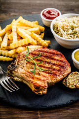 Fried pork chop, French fries and vegetable salad
