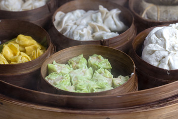 Fresh dim sum in bamboo steamer, chinese cuisine for sale at a local market in Bali, Indonesia. Close up