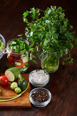 Fresh vegetable salad and ripe veggies on cutting board over wooden background, close up, selective focus