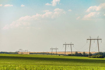 Landscape with air line supports. Intermediate steel overhead transmission line supports on a...