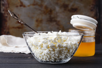 Natural homemade cottage cheese on dark table