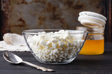 Natural homemade cottage cheese on dark table
