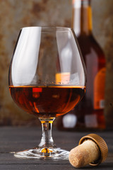 Whiskey in glass on rusty table background
