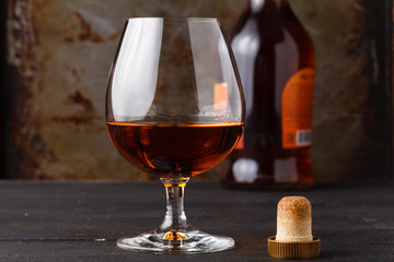 Whiskey in glass on rusty table background