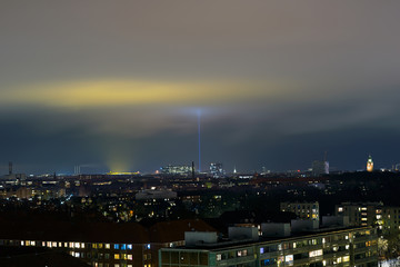 Fototapeta na wymiar Blue laser loop that lights up from the city into the cloud