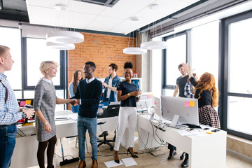 african happy volunteer is thanking Caucasian woman with short fair hair for help to sick children.thank gesture