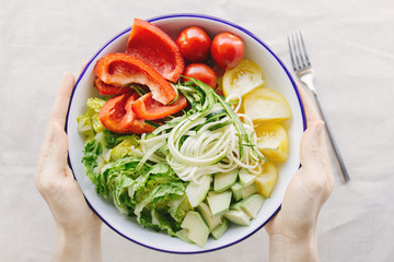 Person with bowl of salad