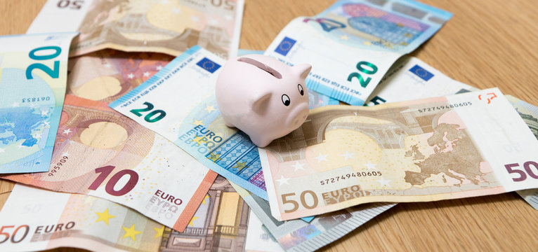 Piggy bank closeup, money and finance concepts. Photographed with Euro currency