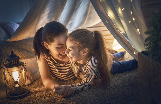  mother and daughter playing in tent