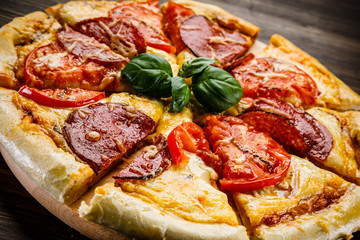 Pizza salami on wooden background
