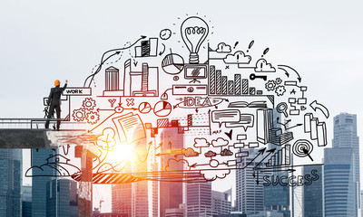 Businessman drawing business conceptual sketches.