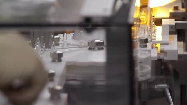 Sealing of the ampoules with the vaccine. Work at a modern pharmaceutical plant.
