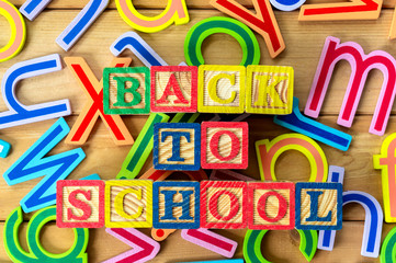 Back to school. Close up arrangement of "Back to School" alphabet on wooden background. Preschool, education, back to school and copy-space concept or other your content.