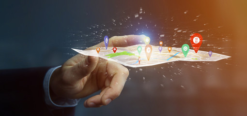 Businessman holding a 3d rendering pin holder on a map