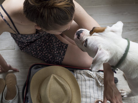 Young Woman In Packing For Summer Holiday