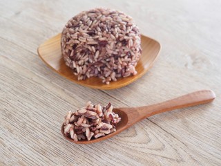 Thai Steam Rice Berry in a wooden dish and spoon on an old wooden table in a healthy diet. And the benefits of nutrition. Strengthens the body and shape.