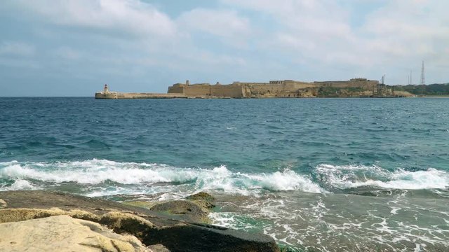 View of the Mediterranean Sea, Fort Ricasoli and the island of Malta from the coast of Valletta.