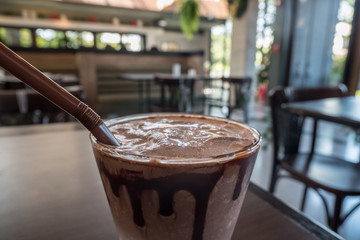 Close up of coco frappe with blurred restaurant background