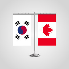 Table stand with flags of South Korea and Canada.Two flag. Flag pole. Symbolizing the cooperation between the two countries. Table flags