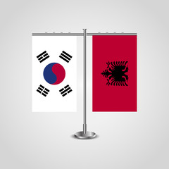 Naklejka na ściany i meble Table stand with flags of South Korea and Albania.Two flag. Flag pole. Symbolizing the cooperation between the two countries. Table flags