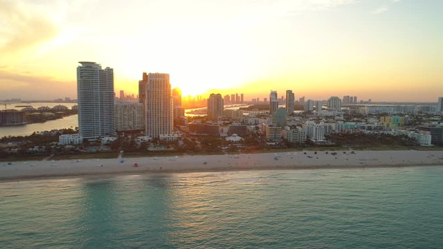 Aerial arrival Miami Beach Florida orange glowing sunset
