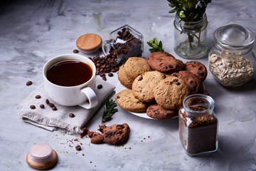 Breakfast background with mug of fresh coffee, homemade oatmeal cookies, grind coffee