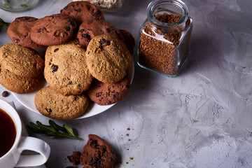 Breakfast background with mug of fresh coffee, homemade oatmeal cookies, grind coffee