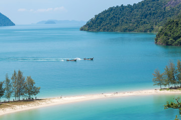 White sand beach and Long-tail boat at Kham-Tok Island (koh-kam-tok), The beautiful sea Ranong Province, Thailand.