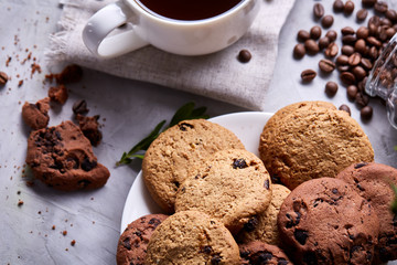 Breakfast background with mug of fresh coffee, homemade oatmeal cookies, grind coffee